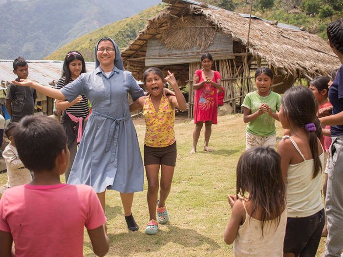 Una misionera religiosa con un grupo de niños
